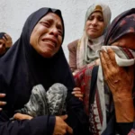 The mother of a Palestinian teenager killed by Israeli fire mourns during his funeral at a hospital in Gaza City in August