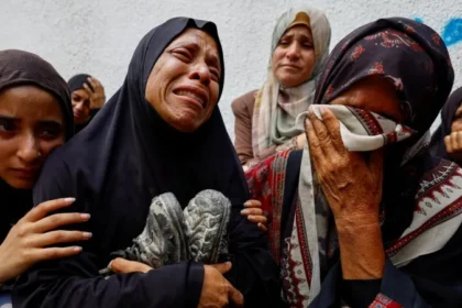 The mother of a Palestinian teenager killed by Israeli fire mourns during his funeral at a hospital in Gaza City in August