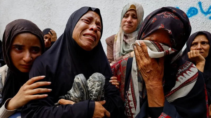 The mother of a Palestinian teenager killed by Israeli fire mourns during his funeral at a hospital in Gaza City in August
