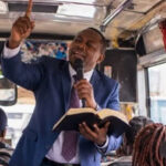Pastor preaching on a bus